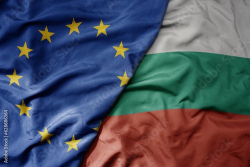 big waving realistic national colorful flag of european union and national flag of bulgaria .