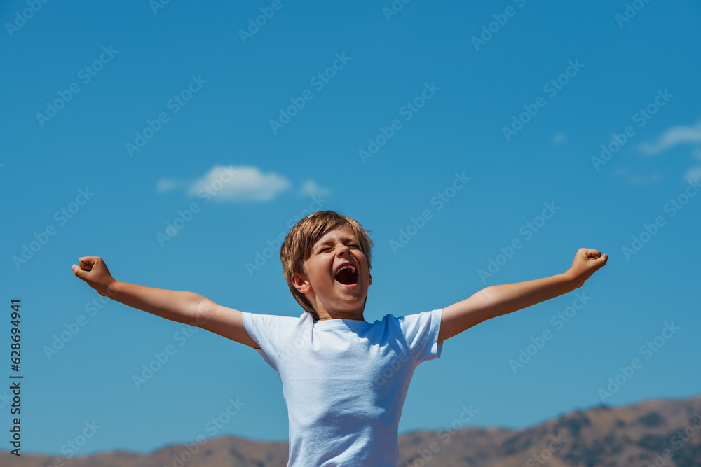 Happy boy yawn and stretch hands on mountains background Happy boy yawn and stretch hands on mountains background