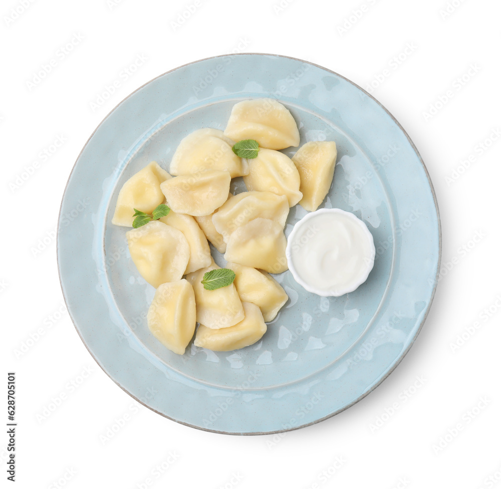 Plate of delicious dumplings (varenyky) with cottage cheese,mint and sour cream isolated on white, top view