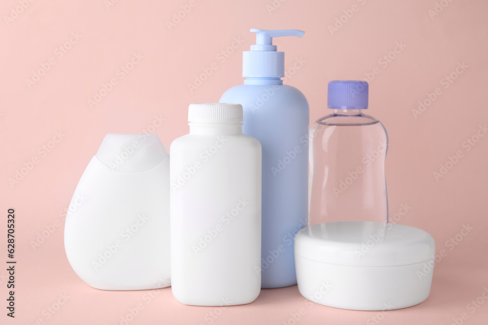 Different skin care products for baby on light coral background. Space for text Different skin care products for baby on light coral background. Space for text