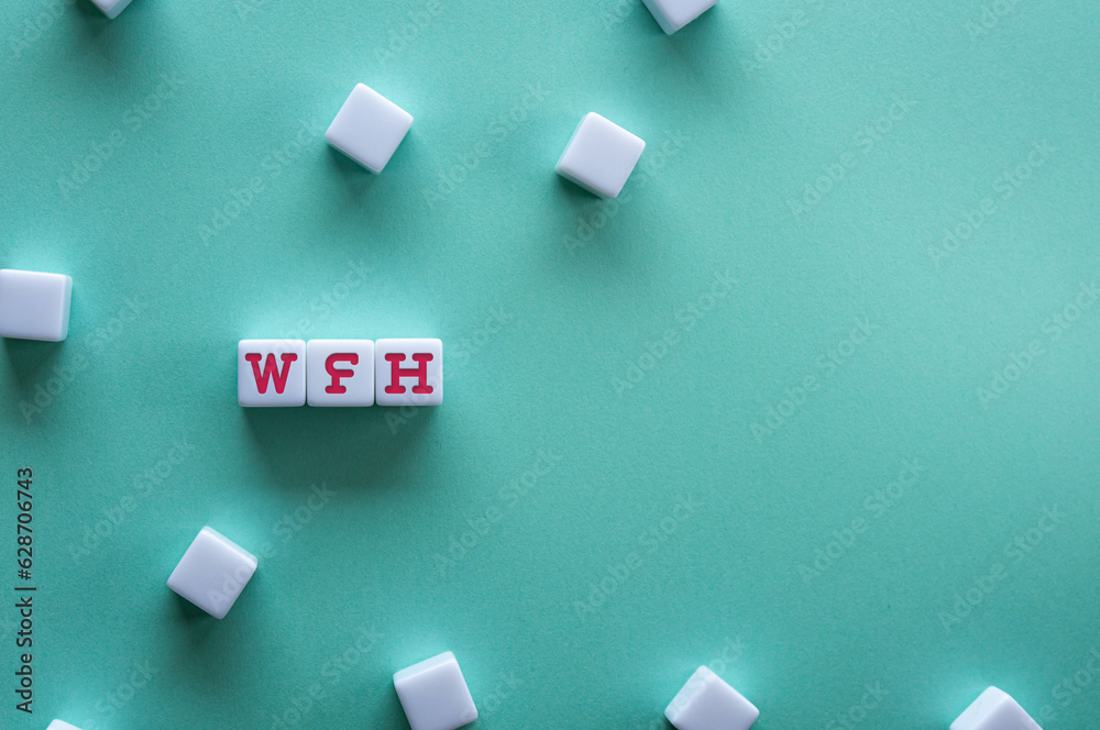 There is white cube with the word WFH. It is an abbreviation for Work From Home as eye-catching image. There is white cube with the word WFH. It is an abbreviation for Work From Home as eye-catching image.