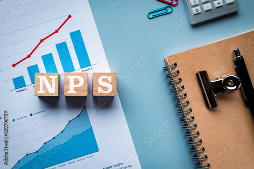 There is wood cube with the word NPS. It is an abbreviation for Net Promoter Score as eye-catching image. photo