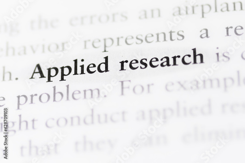 term applied research printed in textbook focused in closeup of explanation