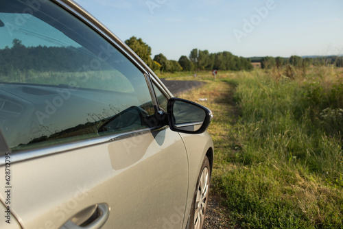 Car on the country road surrounded by nature. © Munka