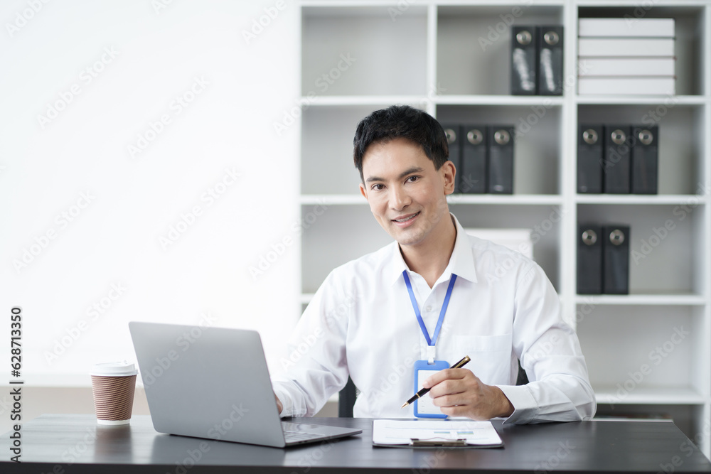 Portrait of young handsome Asian businessman working with laptop computer in the office room. Portrait of young handsome Asian businessman working with laptop computer in the office room.