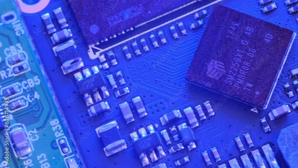 Microchip flashing neon light tracking shot close up. Inside of electronic device. CPU Processor, Transistors, Semiconductors.