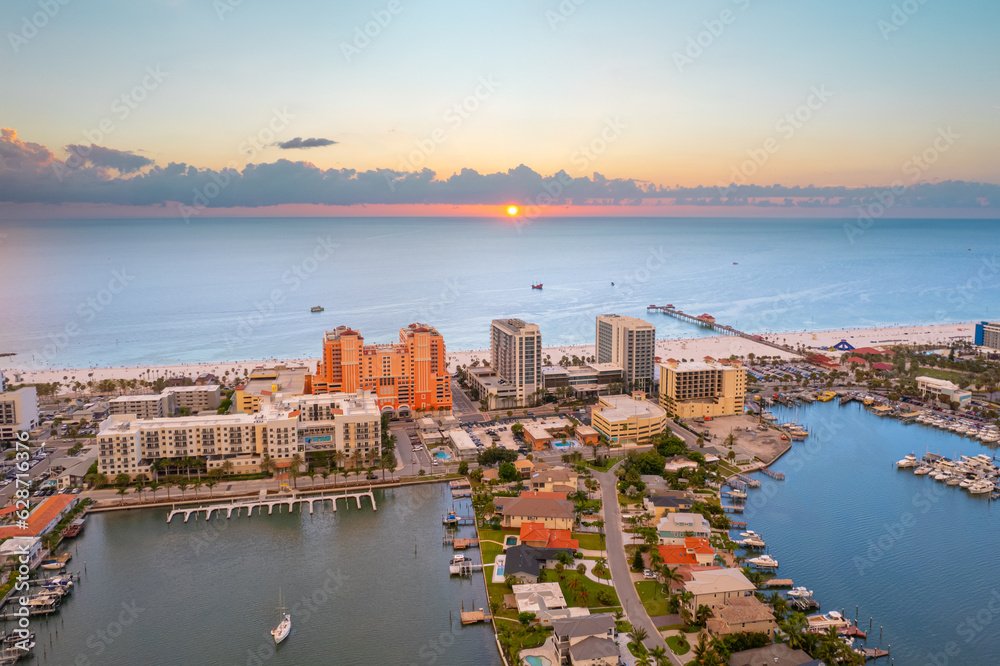 Panorama of city Clearwater Beach FL. Summer vacations in Florida. Beautiful View on Hotels and Resorts on Island. Colorful Sunset. Colored sky. Ocean water. American Coast or shore Gulf of Mexico