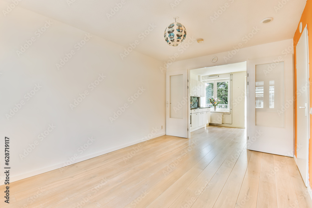 an empty living room with hardwood flooring and white walls in the room is very clean, but there is no light an empty living room with hardwood flooring and white walls in the room is very clean, but there is no light
