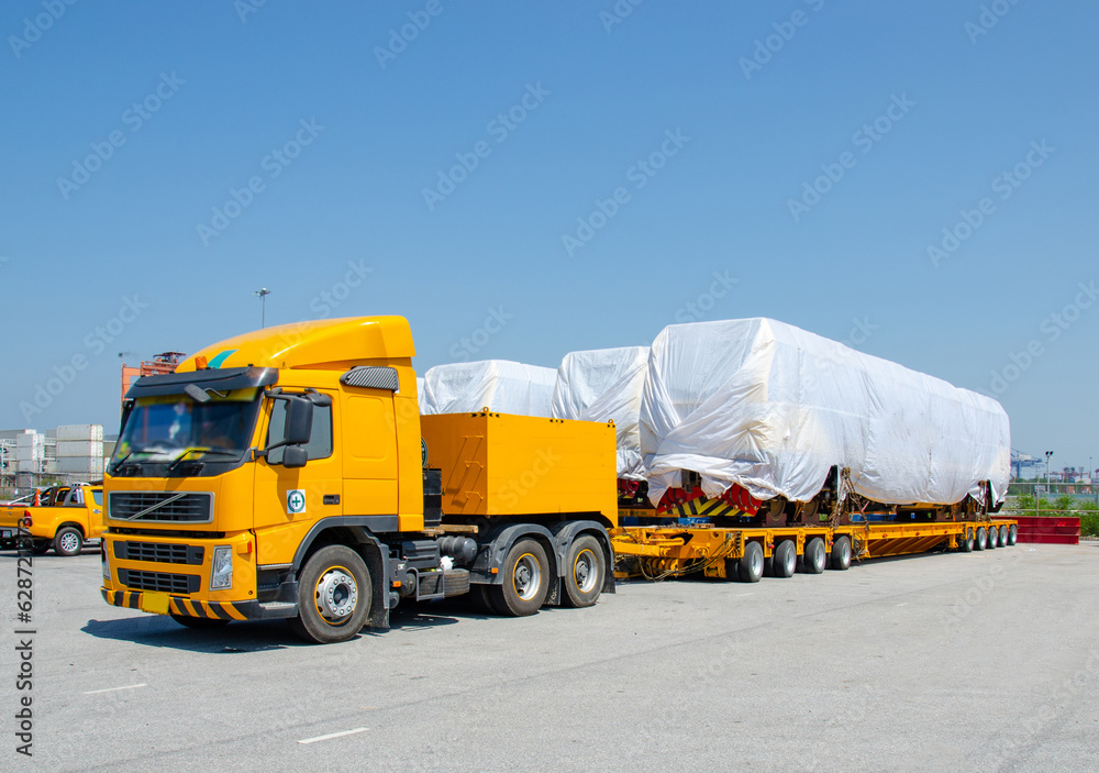 Transport of Oversize Heavy cargo trailera new diesel-electric locomotive on a multi-axle hydraulic modular truck trailer Loading a port area