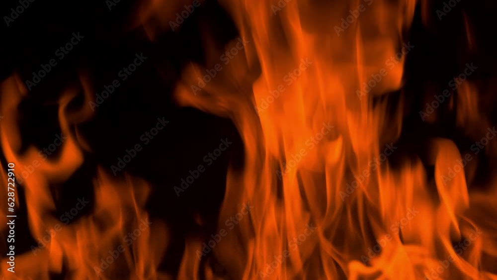 Fire flame burning and glowing on dark black background Fire flame burning and glowing on dark black background