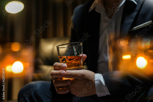 Closeup businessmen holding a glass of whiskey