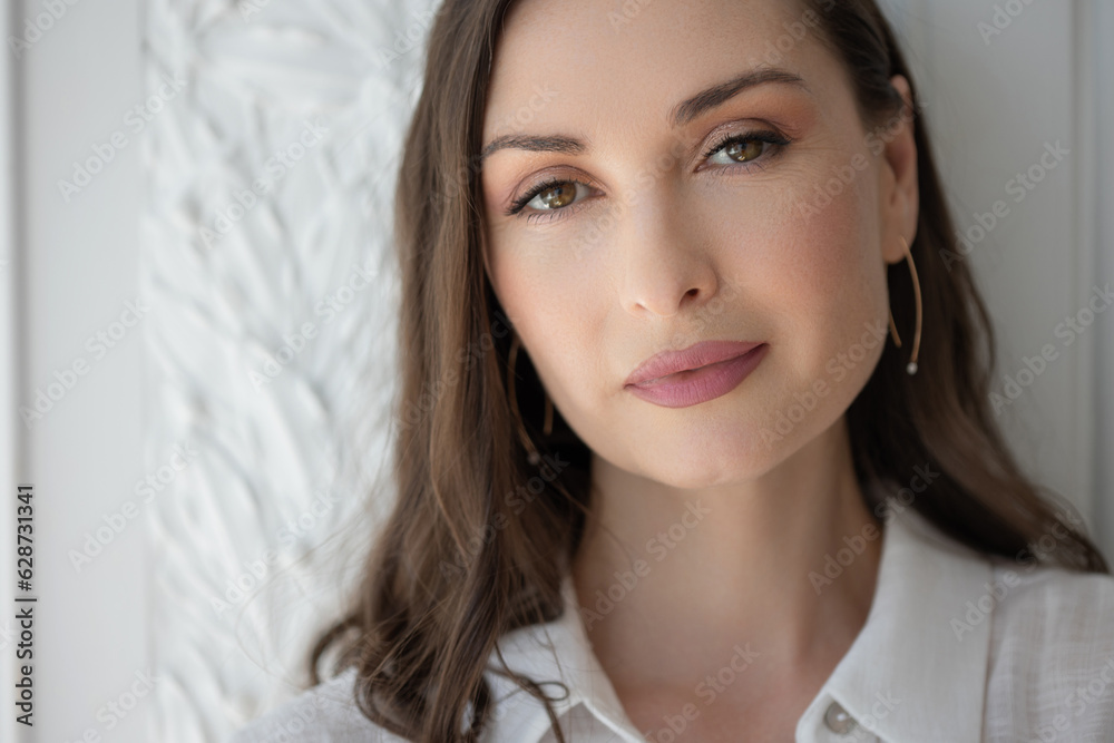 Stylish confident woman in a white shirt, close-up portrait. Natural beauty, woman 35-45 years old Stylish confident woman in a white shirt, close-up portrait. Natural beauty, woman 35-45 years old