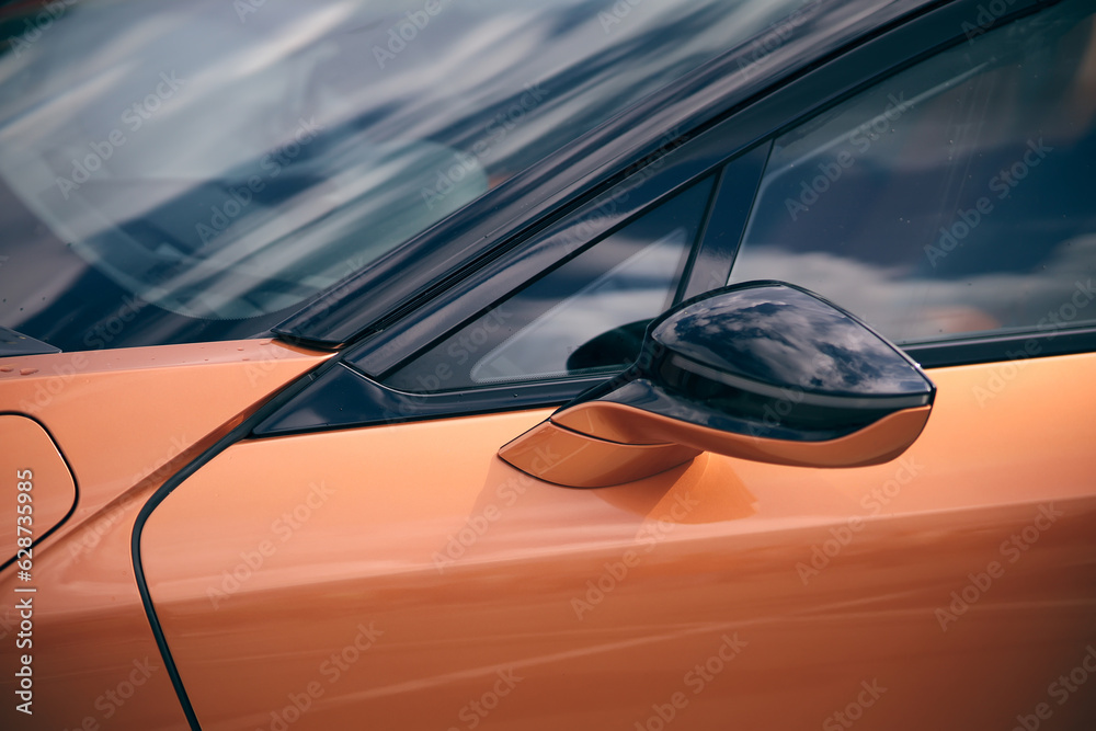Obraz premium Orange tuned sports luxury car fragment. Sport car at the start.