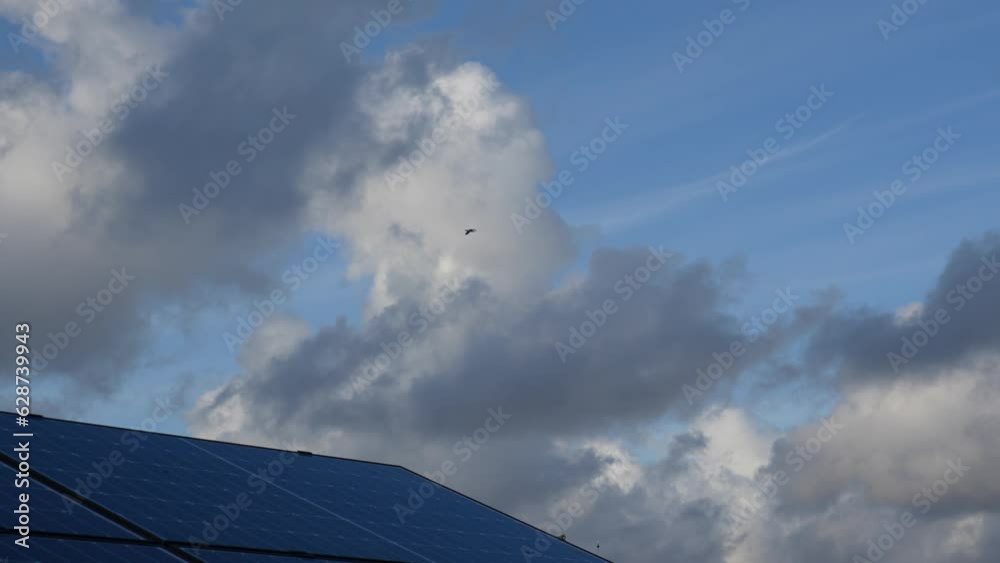 Solar panels with a sky full of clouds in the background in the strong wind. Solar panels with a sky full of clouds in the background in the strong wind.