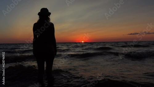 Romantic girl sees off the passing day and looks into the new day