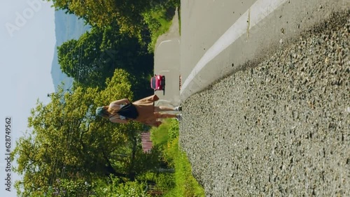 Vertical tourist walks along a hot highway under the scorching rays of the sun photo