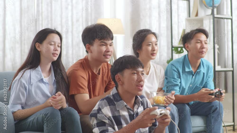 Asian Teenagers Playing Video Games And Celebrating Victory At Home
Asian Teenagers Playing Video Games And Celebrating Victory At Home