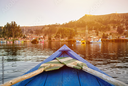 wooden boat tip and colors on a lake at sunset in bolivia hispanic america photo