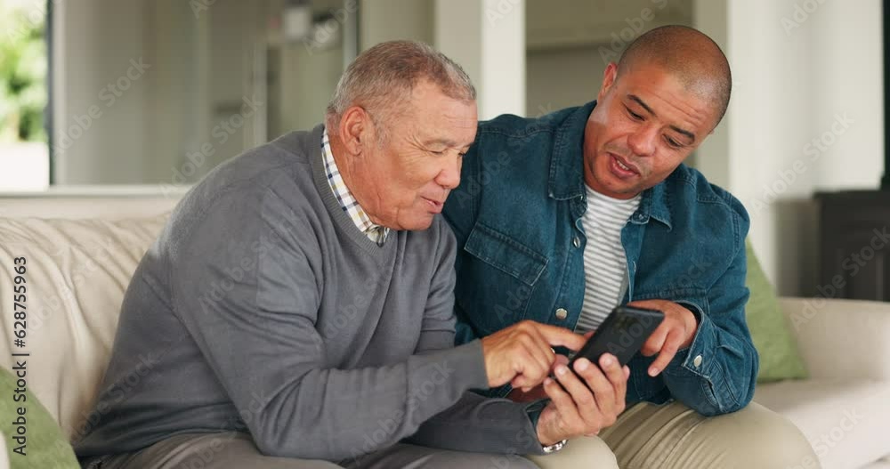 Phone, couch and senior father with man search social media, web and website in a home together in a living room. Discussion, conversation and elderly person talking with son on internet in a lounge Phone, couch and senior father with man search social media, web and website in a home together in a living room. Discussion, conversation and elderly person talking with son on internet in a lounge
