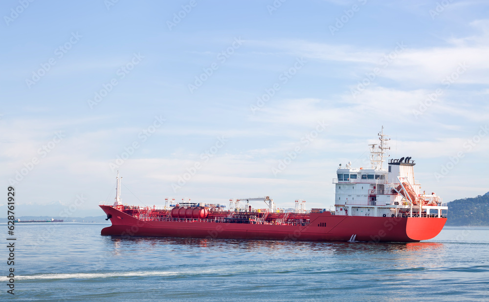 A red ship with drilling equipment leaving the port A red ship with drilling equipment leaving the port