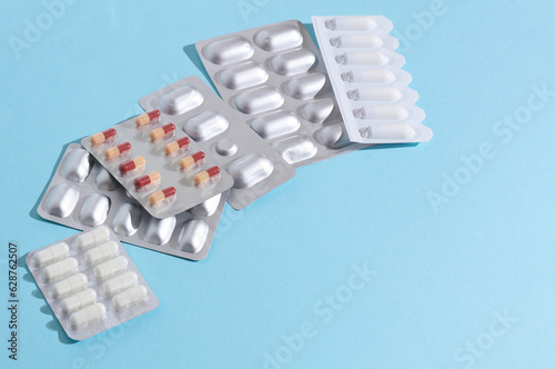 Various medicines, blisters of pills on a blue background. Medicine concept