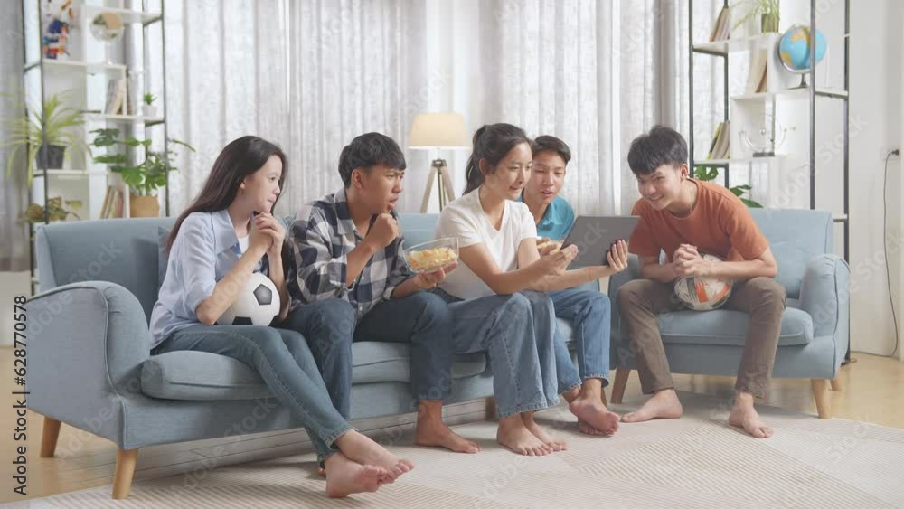 Asian Teenagers Cheering And Watching Football Game On Tablet And Celebrating Victory At Home
Asian Teenagers Cheering And Watching Football Game On Tablet And Celebrating Victory At Home
