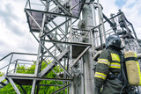 The rescuer looks at the technological equipment.A firefighter in protective clothing and breathing apparatus during the liquidation of an accident at a chemical plant.Gas contamination at the factory