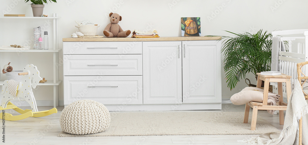 Interior of light children's room with chest of drawers