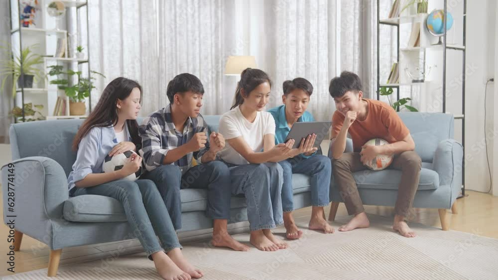 Asian Teenagers Cheering And Watching Football Game On Tablet. Team Celebrating Victory And Team Disappointed
Asian Teenagers Cheering And Watching Football Game On Tablet. Team Celebrating Victory And Team Disappointed