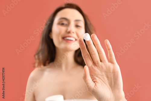 Young woman applying skinca...