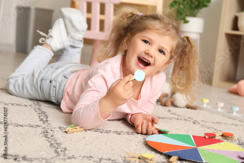 Cute little girl playing ma...