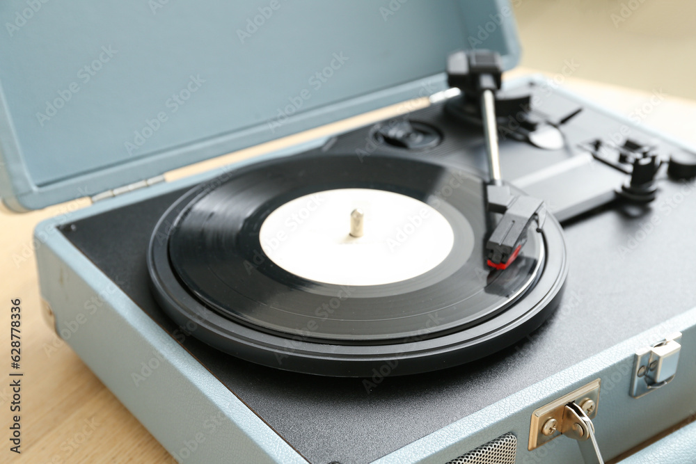 Record player with vinyl disk on table in room, closeup Record player with vinyl disk on table in room, closeup
