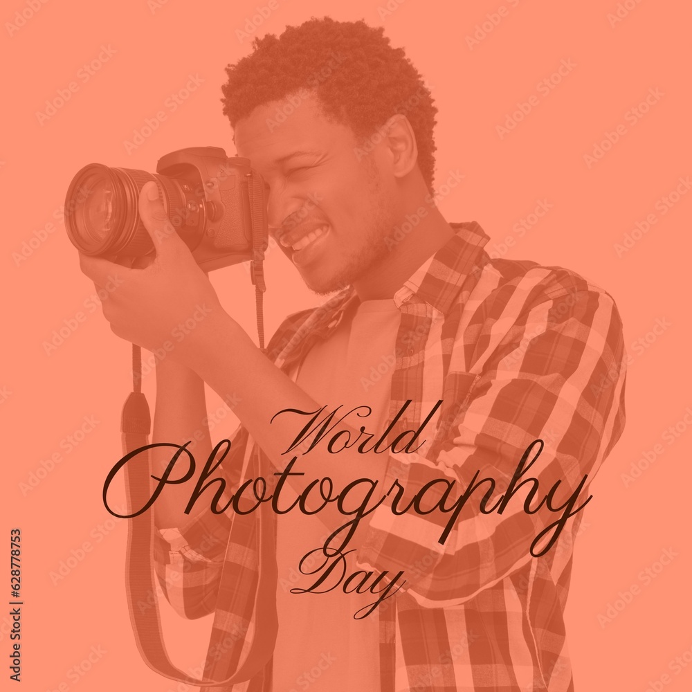 World photography day text on orange with happy african american man using camera World photography day text on orange with happy african american man using camera