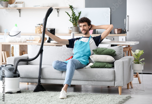 Young man with vacuum clean...