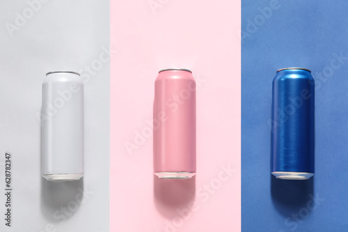 Cans of fresh soda on color...