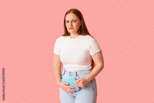 Young woman with hot water ...