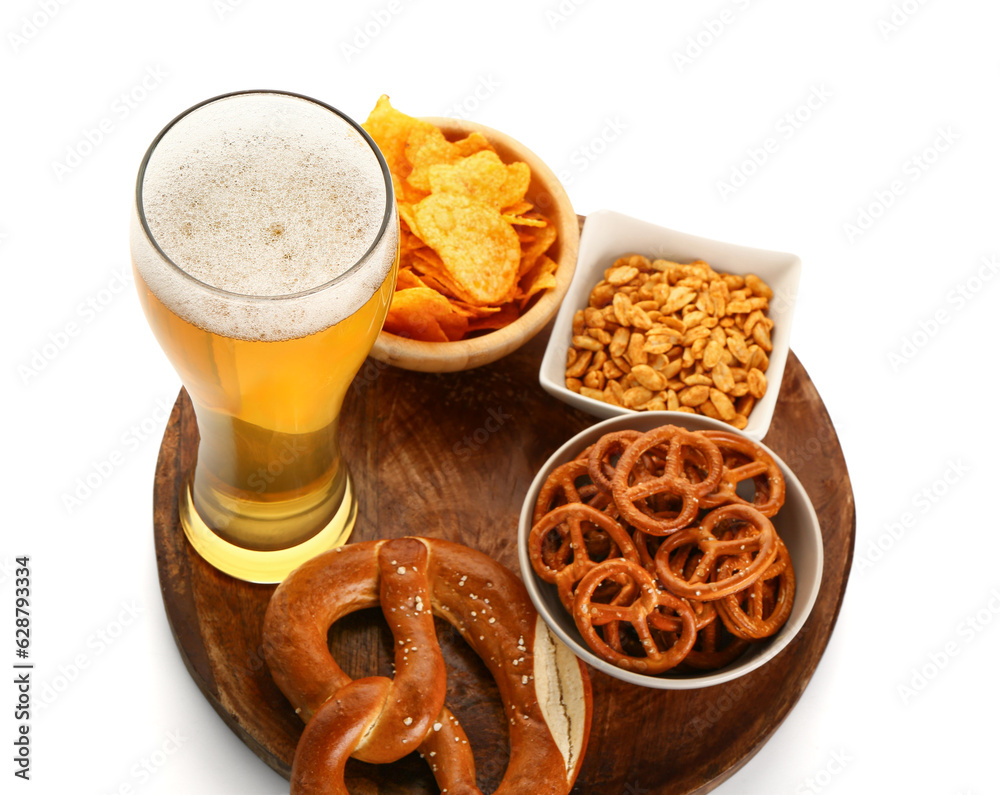 Glass of cold beer and different snacks on white background. Oktoberfest celebration Glass of cold beer and different snacks on white background. Oktoberfest celebration