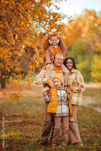 family traditions. multiethnic family spending leisure time in autumn in the park