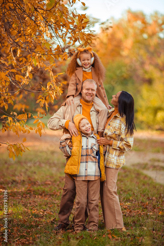 family traditions. multiethnic family spending leisure time in autumn in the park
