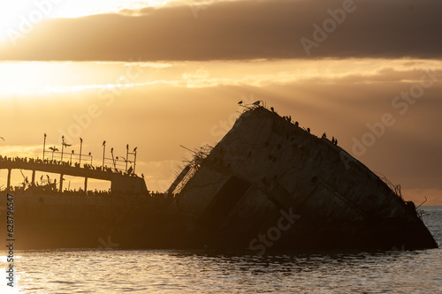 Silhoutte of the SS Palo Alto near sunset, an old World War II shipwreck off the coast of Aptos, Californa photo