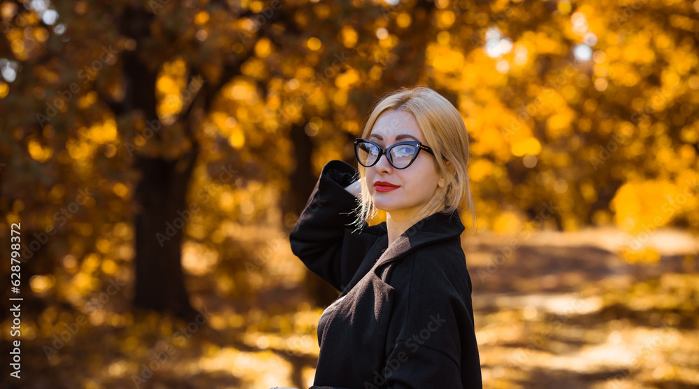 Outdoor atmospheric lifestyle portrait of young beautiful European mixed race lady. Warm autumn