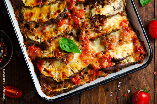 Eggplant Casserole, Roasted Eggplant Dish with Minced Meat, Tomato Sauce and Mozzarella over Rustic Background