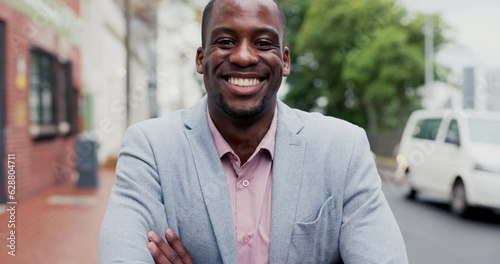 Face, pride and a black man with arms crossed in the city for business or corporate work. Happy, young and portrait of an African businessman with confidence, smile or in an urban astreet for a job photo