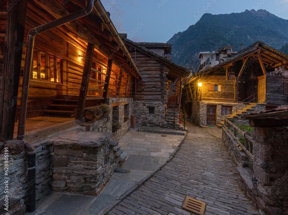 The rural architecture of Alagna village in the Valsesia valley range at dusk - Italy.