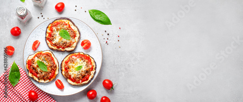 Fototapeta Naklejka Na Ścianę i Meble -  Eggplant Pizza with Tomato Sauce, Minced Meat, Mozzarella and Basil, Mini Vegetable Pizza over Bright Background