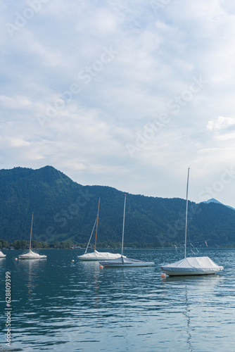 Sailing boats on the water against the background of blue sky and mountains