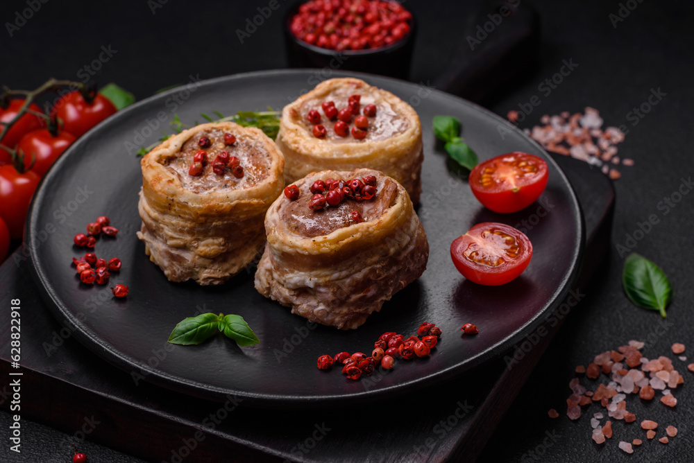 Delicious baked meat roll wrapped in bacon with salt, spices and herbs