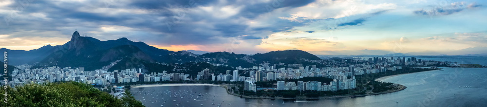 Panoramic aerial view of cityscape Rio de Janeiro, Brazil at sunset, beachfront district. Panorama of Rio city landscape at mountains background. Urban wallpaper concept. Copy ad text space banner