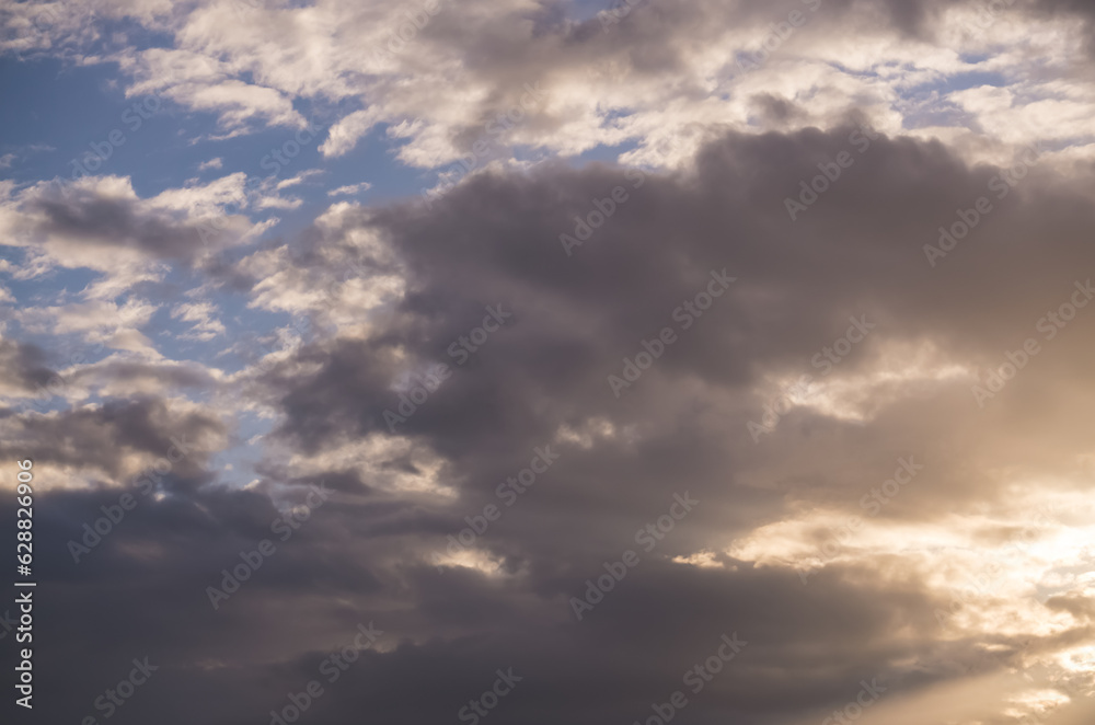 Sky during sunset with clouds and sunbeams, minimalist sky for background