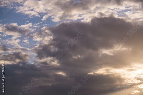 Sky during sunset with clouds and sunbeams, minimalist sky for background